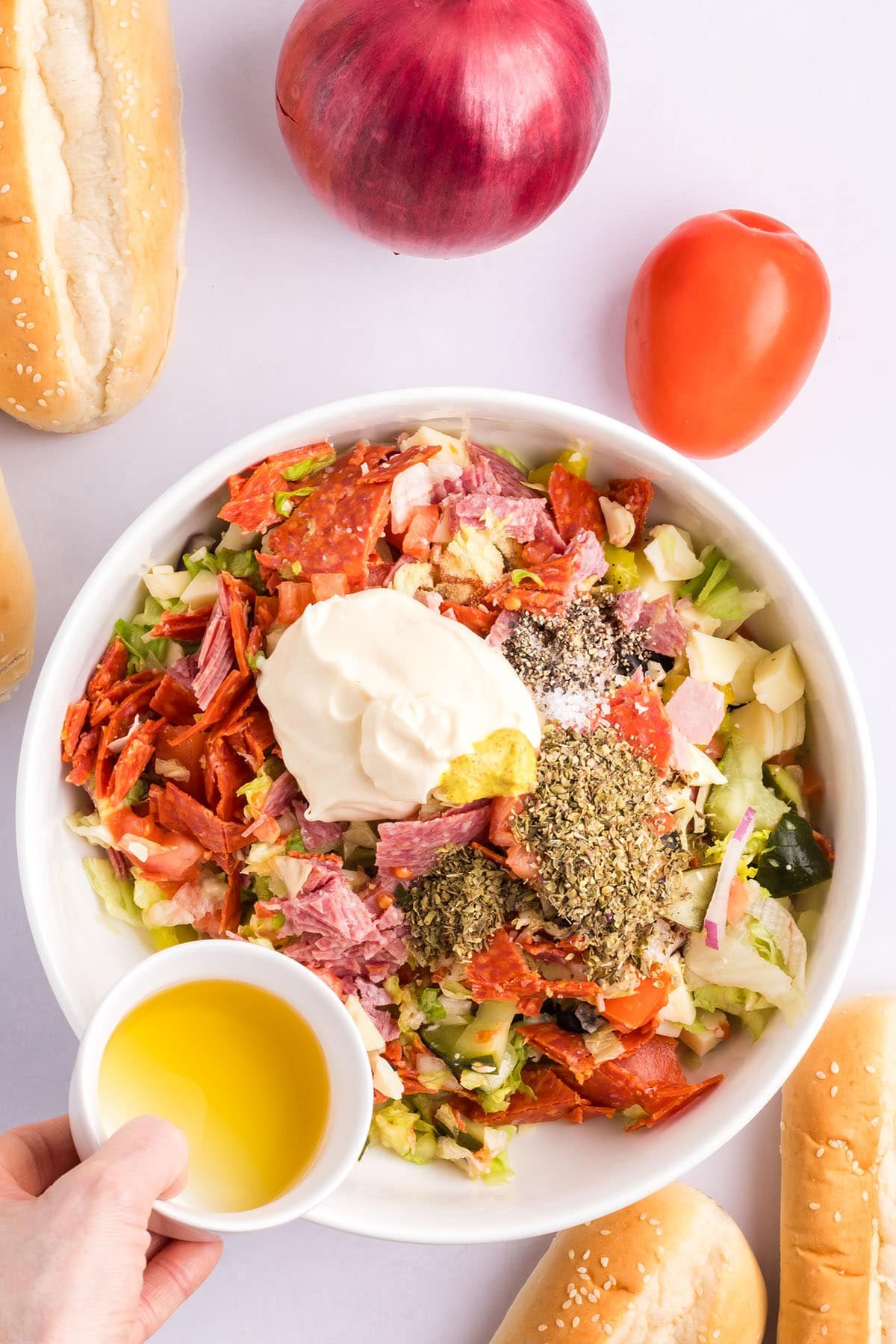 adding Italian dressing to chopped sandwhich ingredients