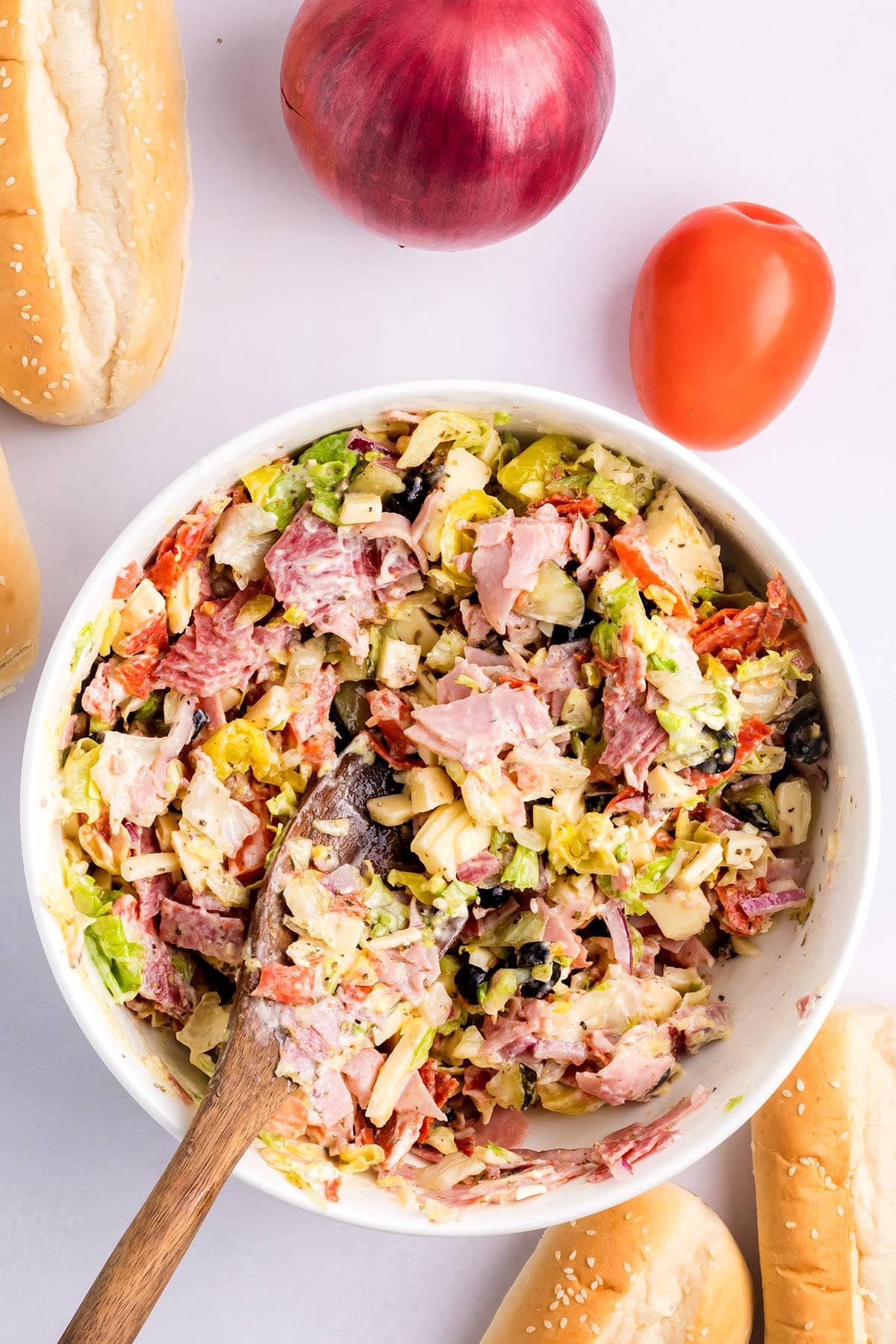 mixing Chopped Italian Sandwich ingredients with homemade dressing
