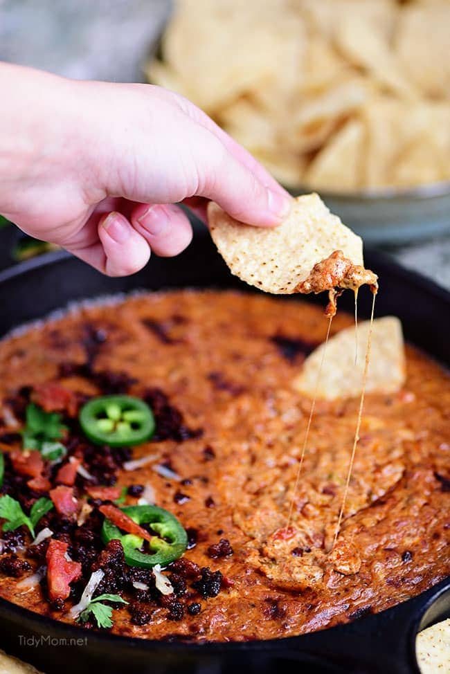 Chorizo Cheese Dip is spicy, cheesy, and the EASIEST dip to make! Packed with, chorizo, tomatoes, green chiles and lots of cheese! This creamy dip is sure to be a hit while watching the Big Game or anytime you need to satisfy that warm gooey cheese craving. See how-to recipe video + print recipe at cetcu.com #dip #appetizer #cheese #cheesedip #chorizo #partyfood