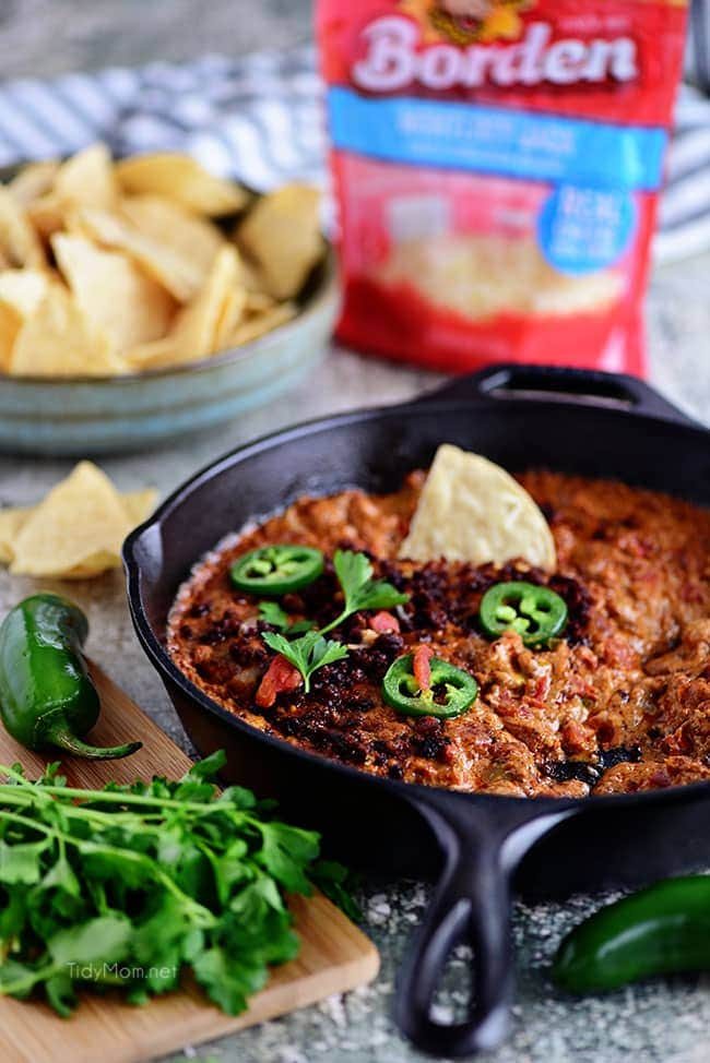 Chorizo Cheese Dip is spicy, cheesy, and the EASIEST dip to make! Packed with, chorizo, tomatoes, green chiles and lots of cheese! This creamy dip is sure to be a hit while watching the Big Game or anytime you need to satisfy that warm gooey cheese craving. See how-to recipe video + print recipe at cetcu.com #dip #appetizer #cheese #cheesedip #chorizo #partyfood