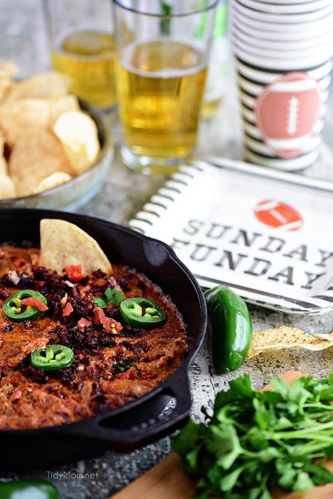 Chorizo Cheese Dip is spicy, cheesy, and the EASIEST dip to make! Packed with, chorizo, tomatoes, green chiles and lots of cheese! This creamy dip is sure to be a hit while watching the Big Game or anytime you need to satisfy that warm gooey cheese craving. See how-to recipe video + print recipe at cetcu.com #dip #appetizer #cheese #cheesedip #chorizo #partyfood