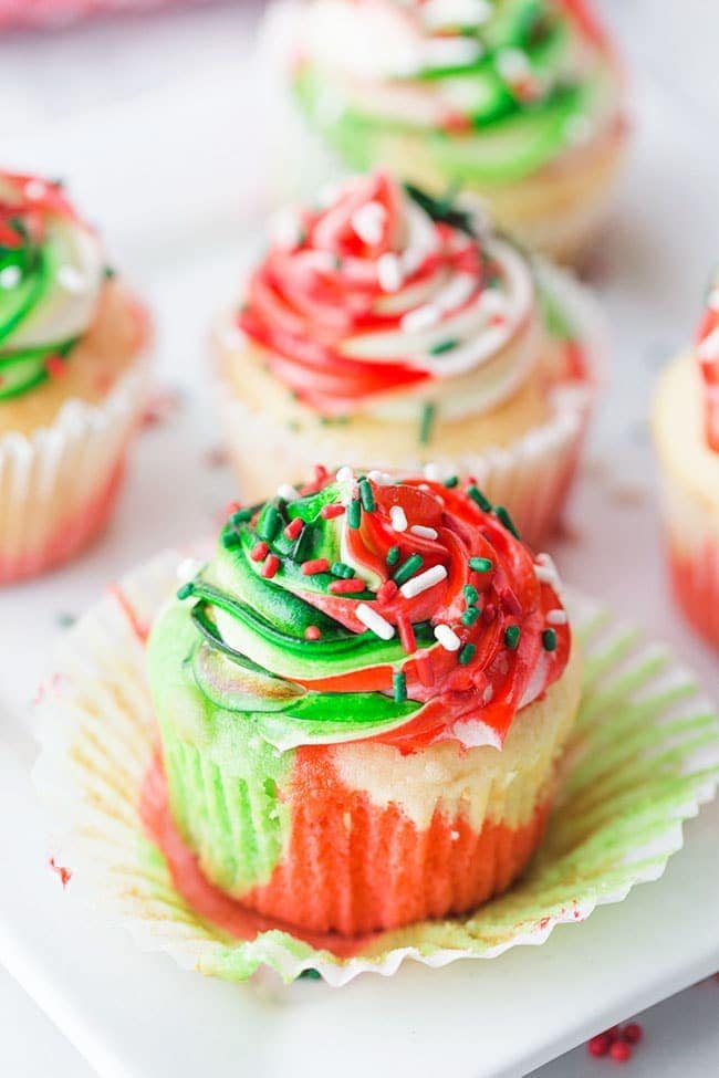 Very Merry Tricolor Christmas Cupcakes in red, green and white with a hint of peppermint! See how to make these fun colorful marble cupcakes and frosting at cetcu.com