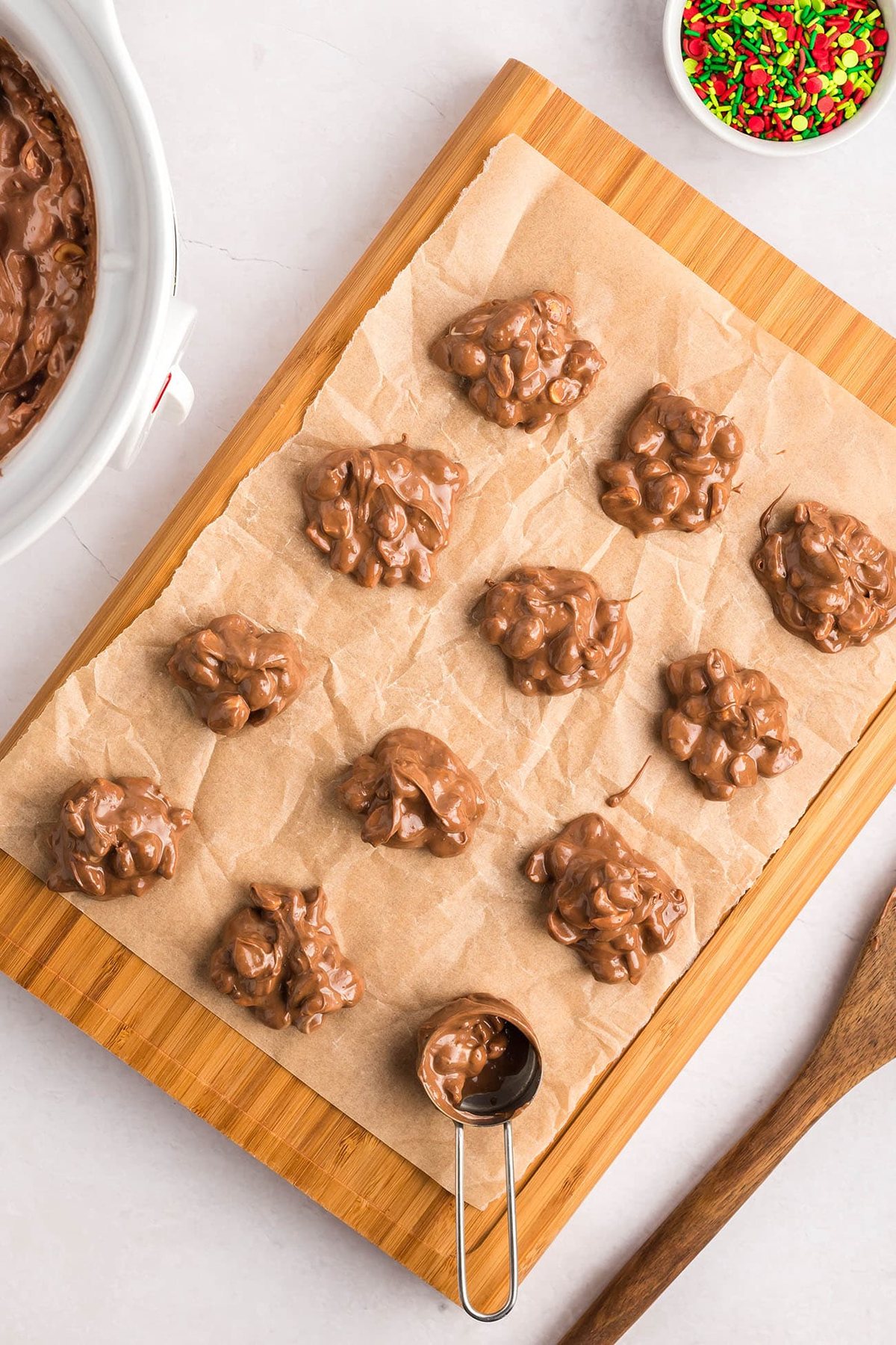 chocolate peanut clusters on a piece of parchment paper