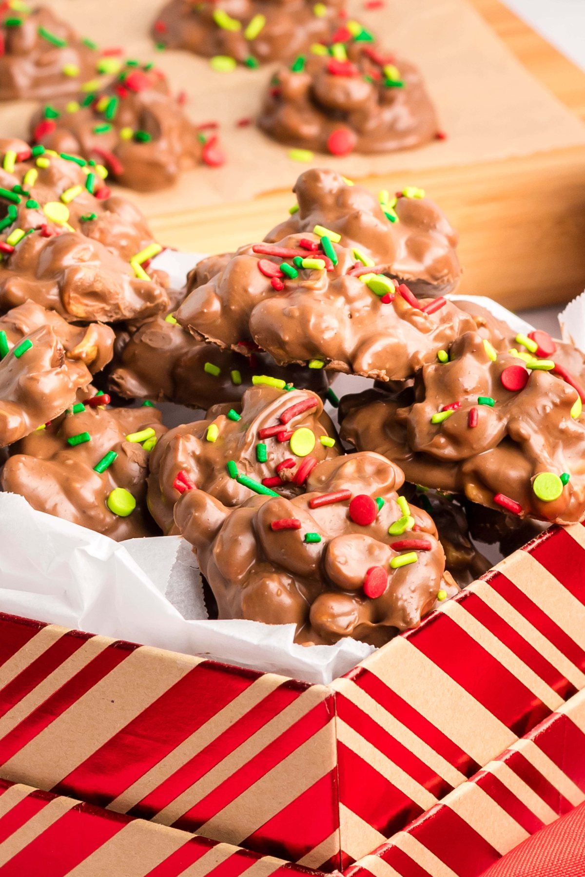peanut clusters with Christmas sprinkles in a holiday box