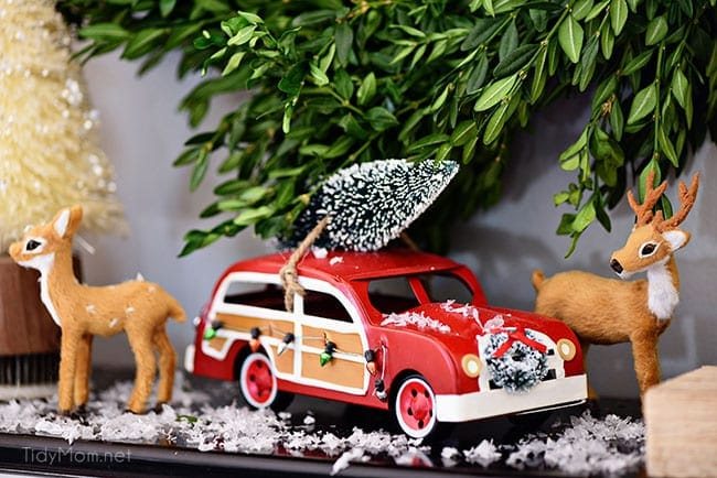Deer and Car Merry and Bright Christmas Mantel Decor with rustic neutrals and a touch of red and green. Details at cetcu.com