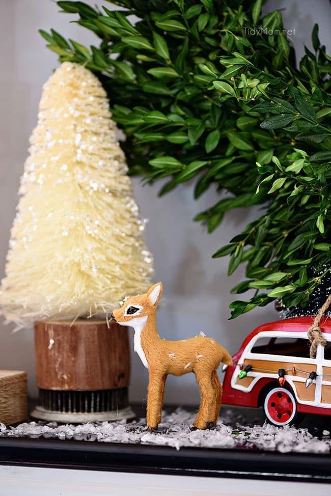 Bottlebrush Tree with doe and car. Merry and Bright Christmas Mantel Decor with rustic neutrals and a touch of red and green. Details at cetcu.com