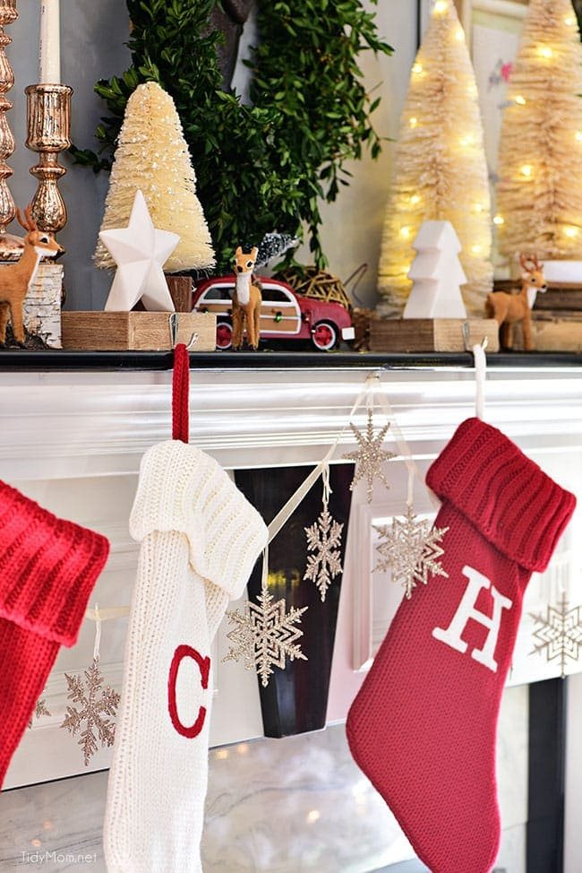Red and white Christmas stockings. Merry and Bright Christmas Mantel Decor with rustic neutrals and a touch of red and green. Details at cetcu.com