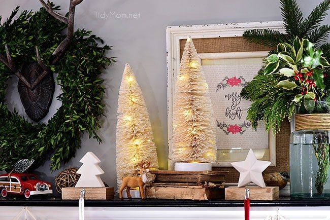 Lighted Bottle Brush Trees. Merry and Bright Christmas Mantel Decor with rustic neutrals and a touch of red and green. Details at cetcu.com