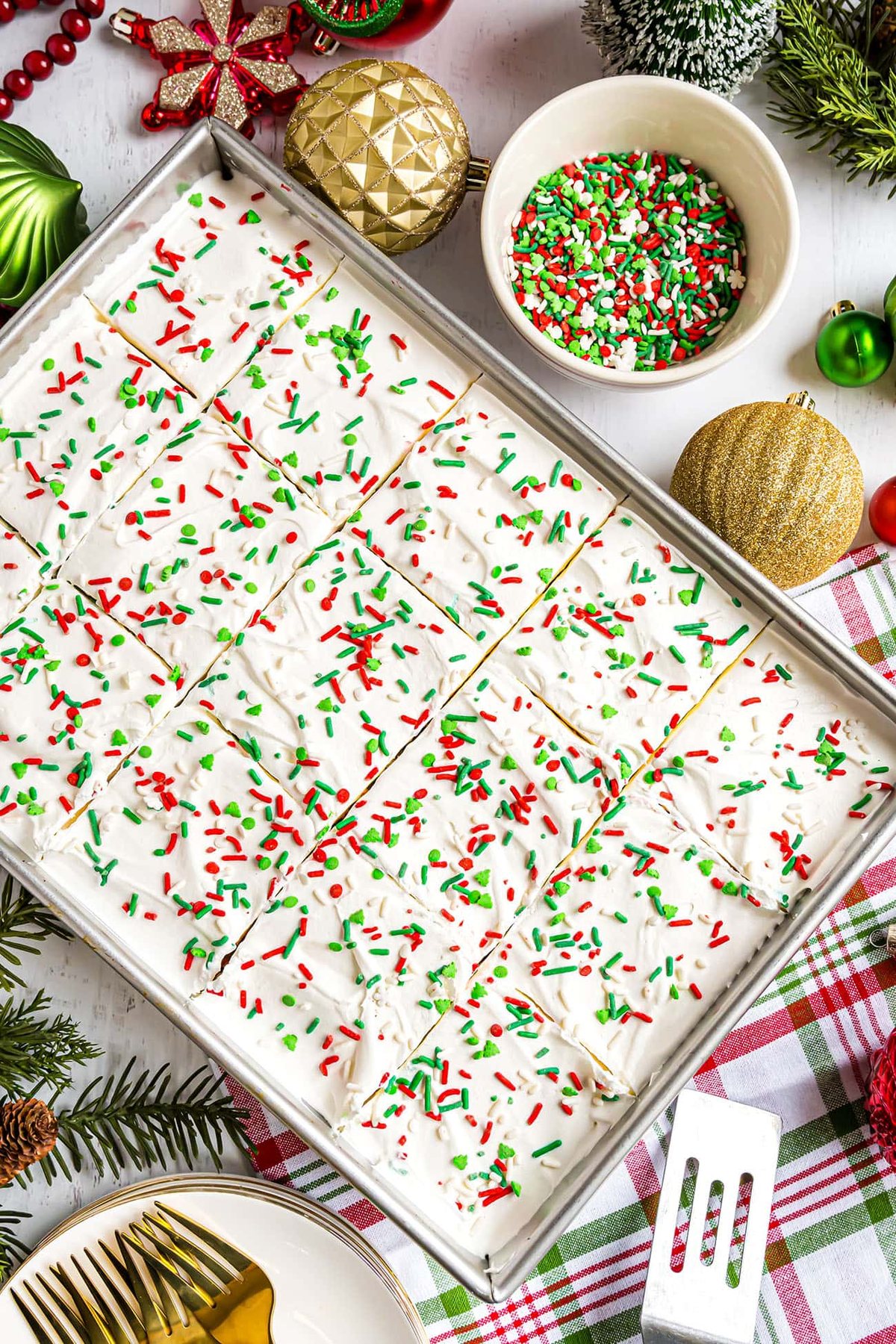 Christmas poke cake with sprinkles in the pan.