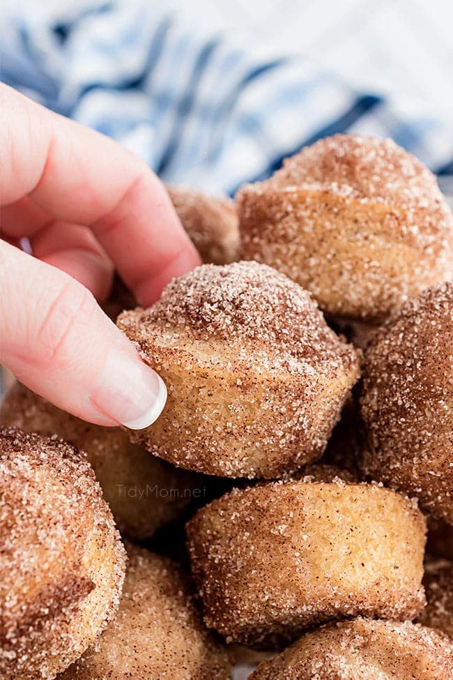 hand grabbing a mini muffin from a basket