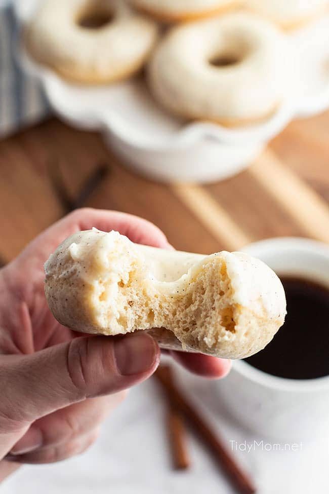 hand holding a cinnamon donut with a bite out
