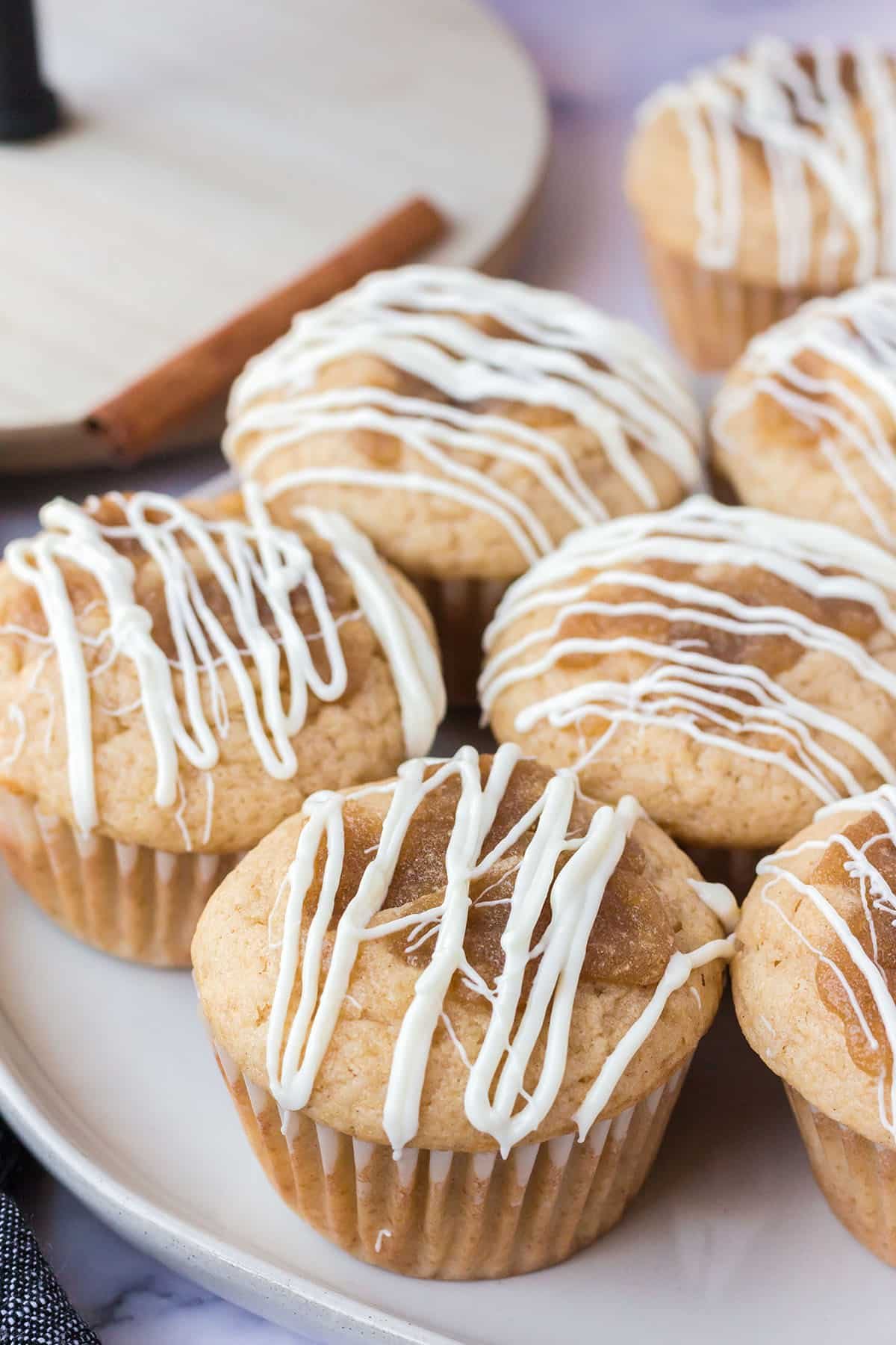 cinnamon roll muffins with white chocolate icing on a plate