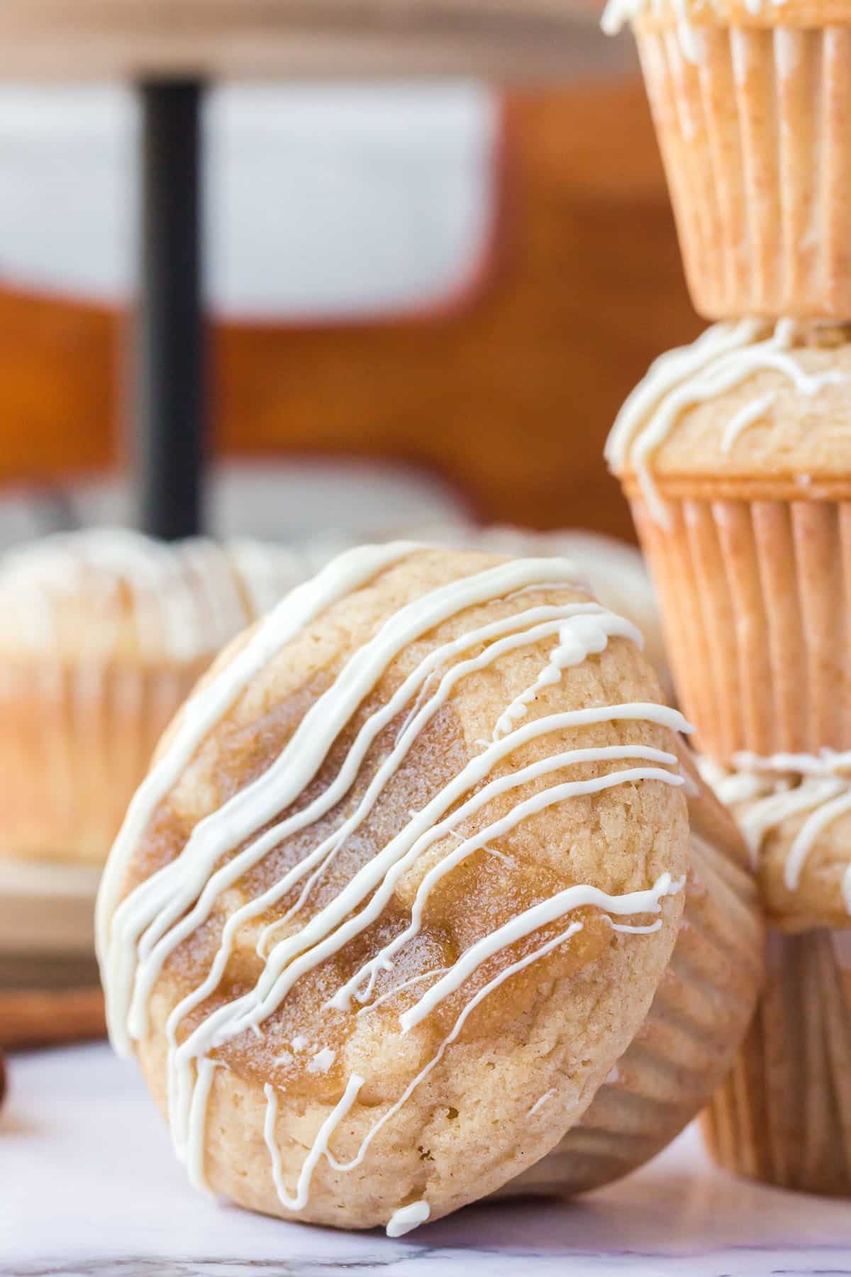 close up of cinnamon roll muffin with white chocolate icing
