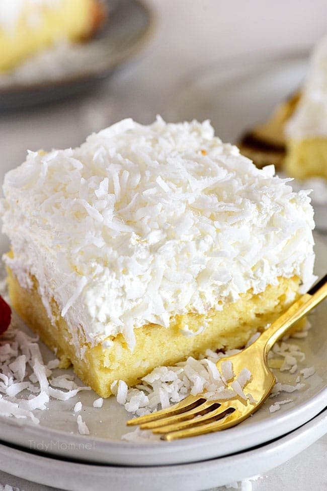 cake with coconut frosting and a fork on a plate