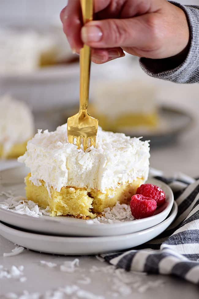 coconut cake with a gold fork poking into it