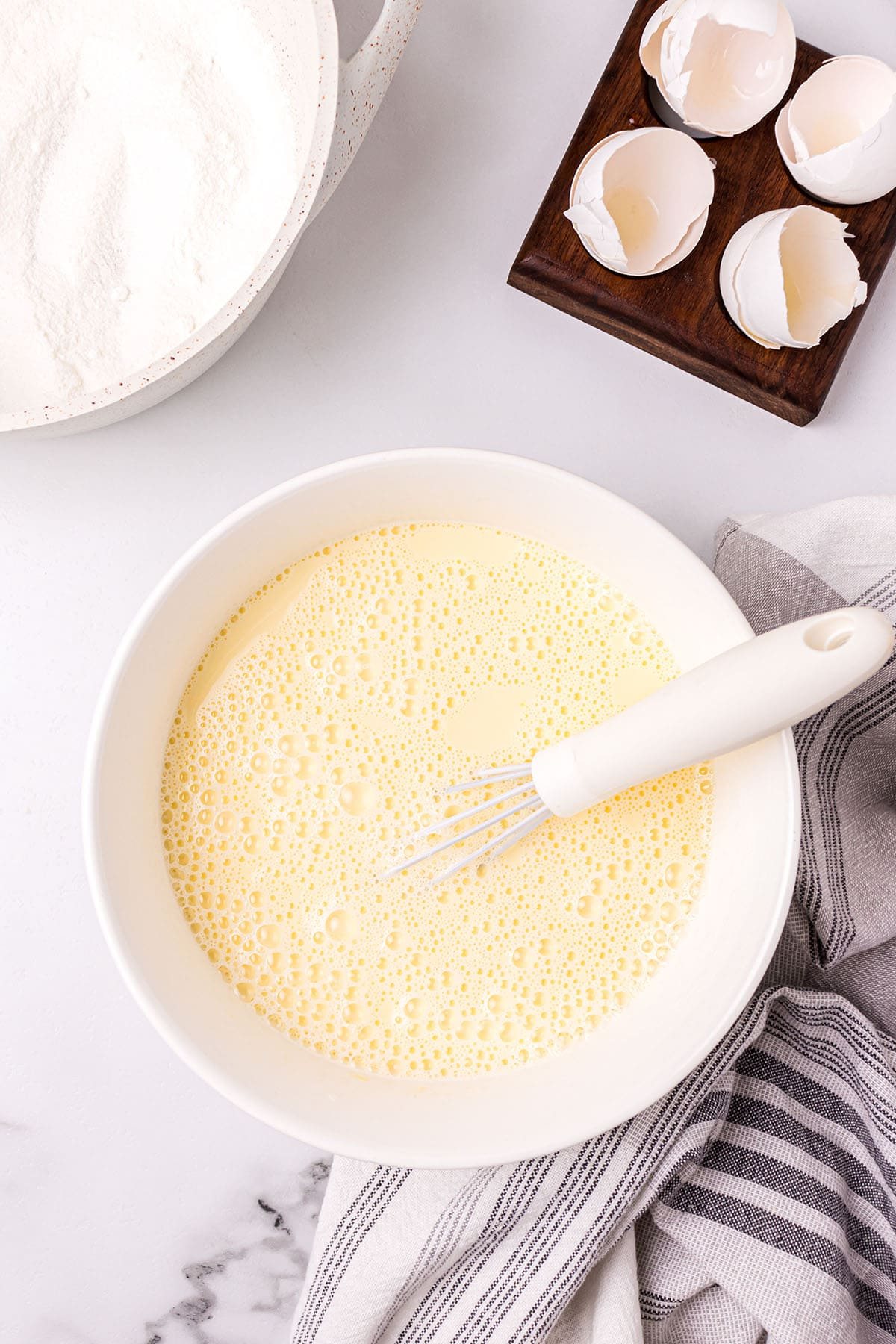 making custard pie filling in a bowl with a whisk