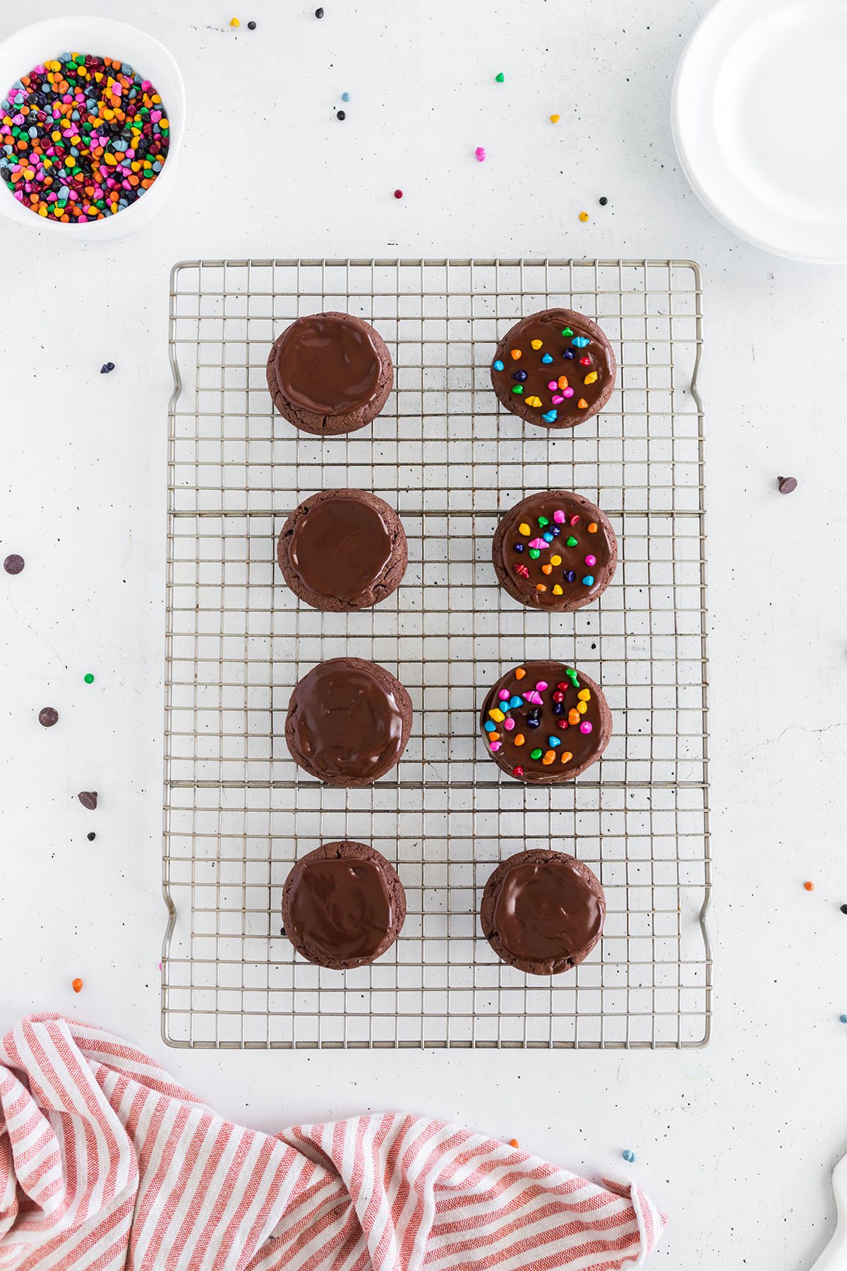 cosmic brownie cookies with rainbow sprinkles on a wire cooling rack