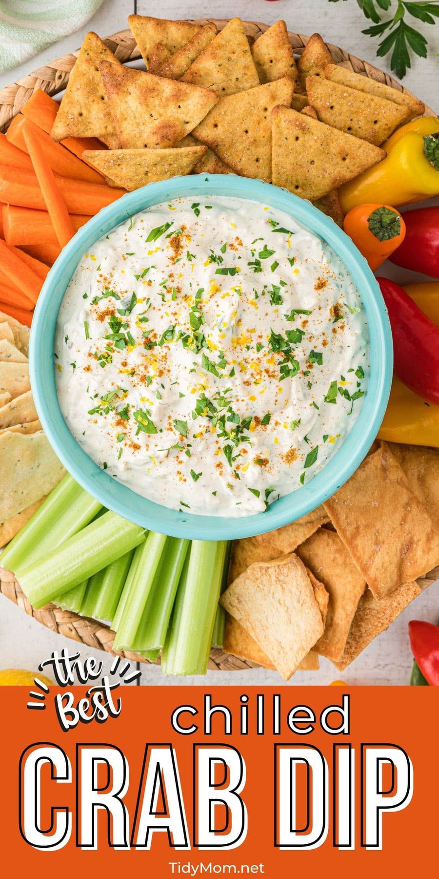 dip in a bowl on a round tray with crackers and veggies