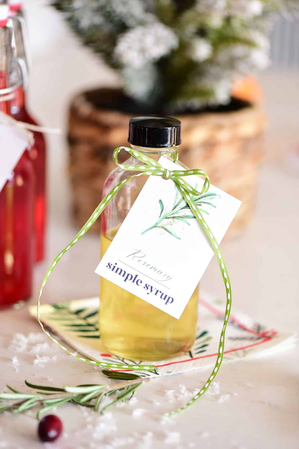 homemade simple syrup in a bottle with a gift tag