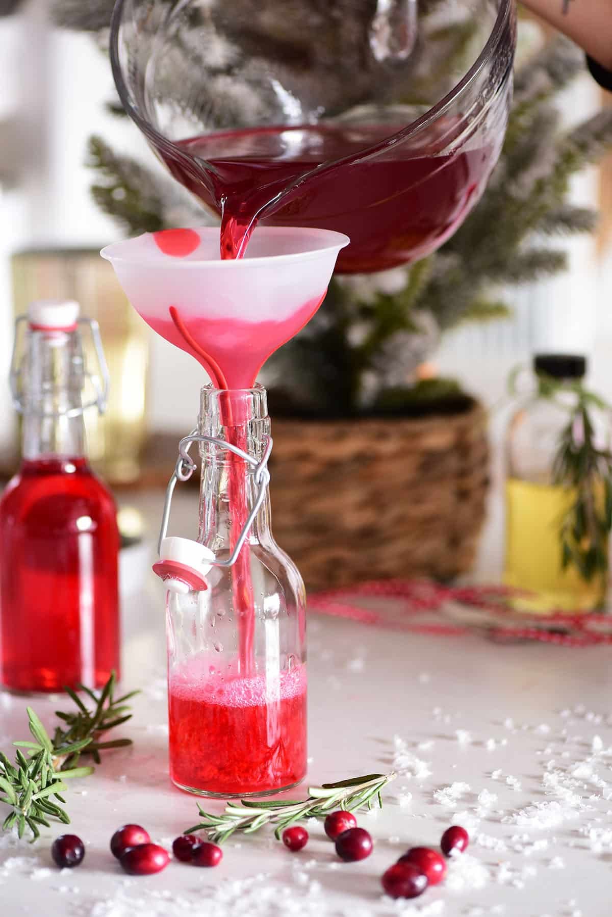 poring vodka into a jar with a funnel