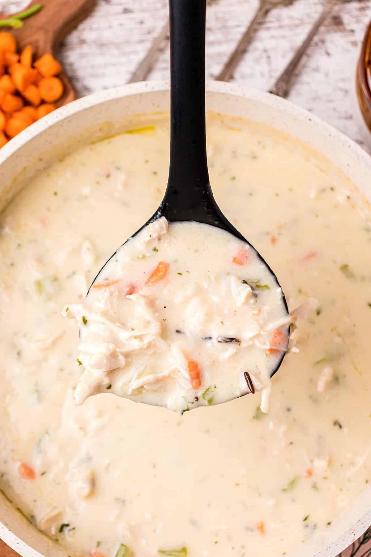 a ladle full of Creamy Chicken And Wild Rice Soup