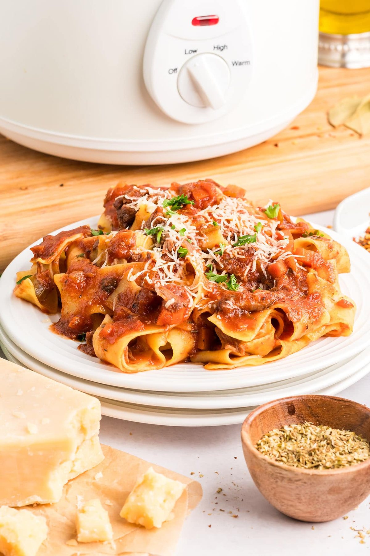 white plates with beef ragu and pasta