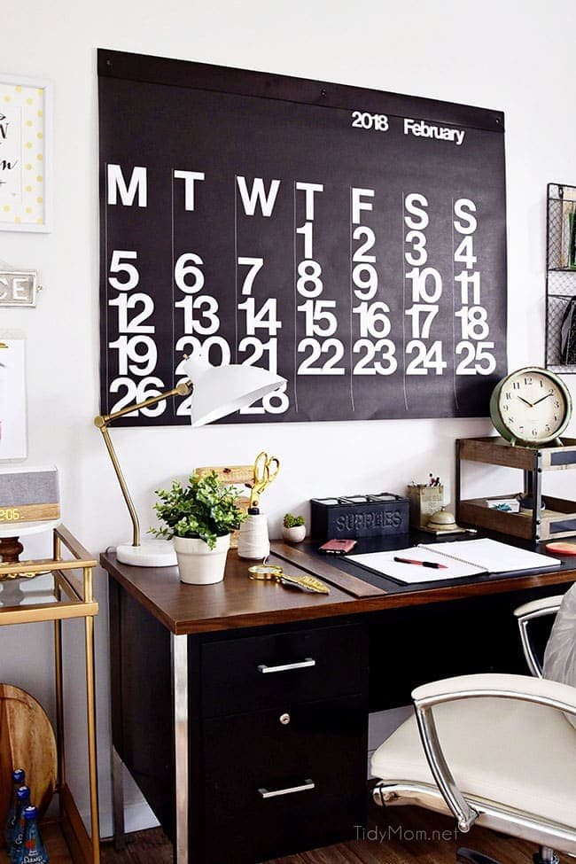 Decorating a shared home office, with colorful industrial style. Her side is pink and gold, while his is black and neutrals. Check out the gold coffee cart and Stendig wall calendar!! Get all the details of this shared home office space at cetcu.com