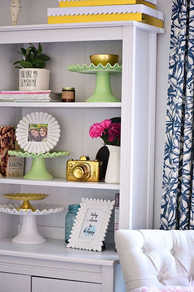 Decorating a shared office, with colorful industrial style. Her side is pink and gold, while his is black and neutrals. Check out the gold coffee cart!! Get all the details of this shared home office space at cetcu.com