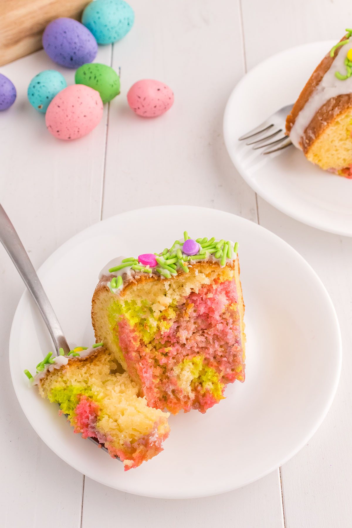 slice of cake on a plate with bite on a fork