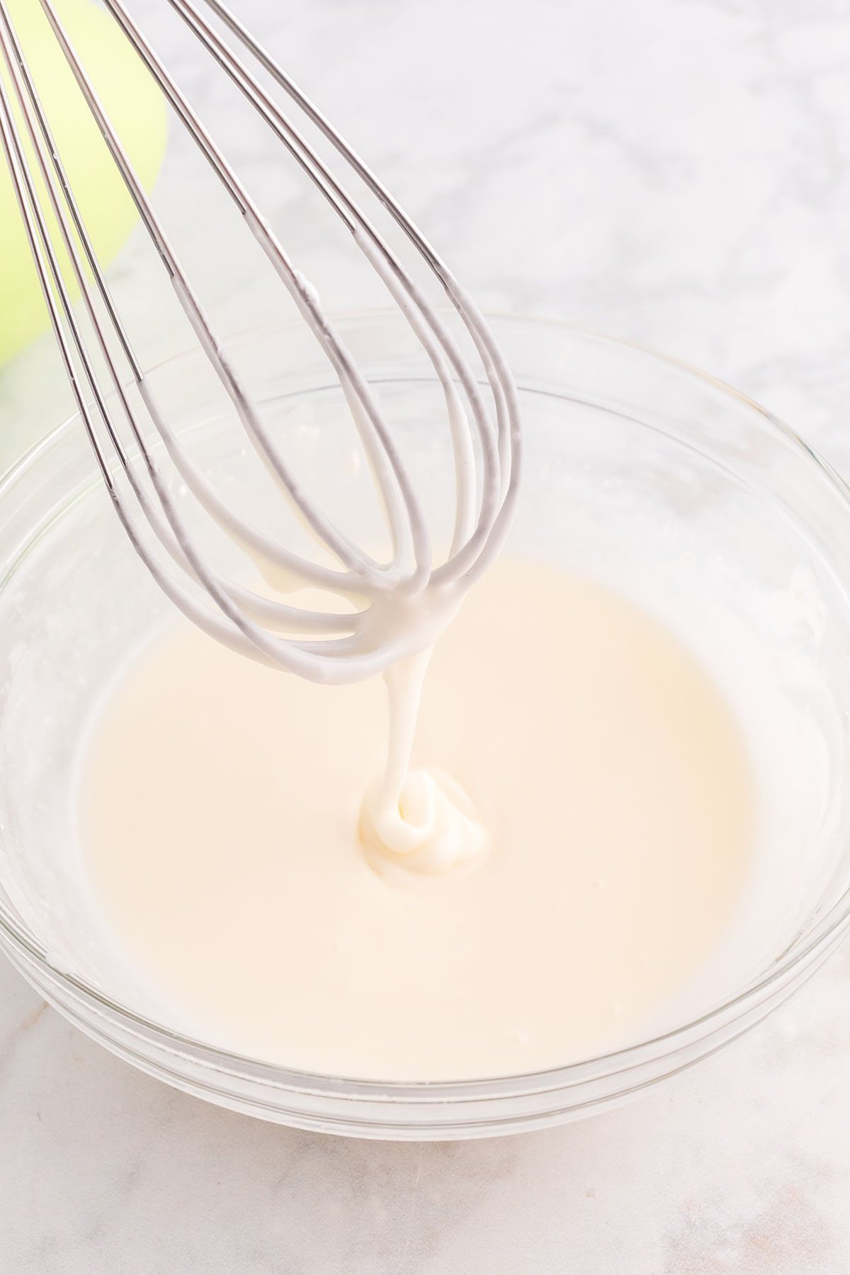 white glaze icing for cake with wire whisk
