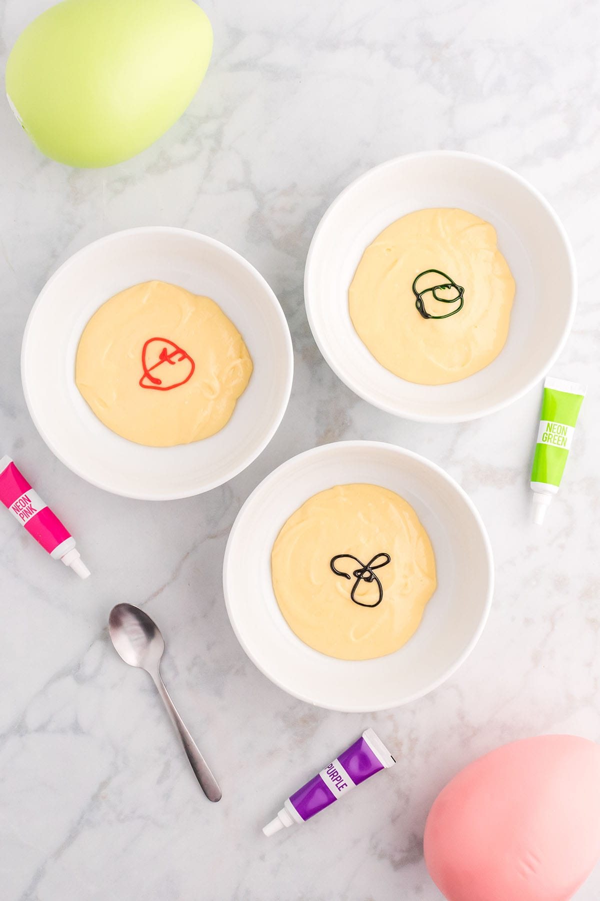 3 bowls of cake batter with food color