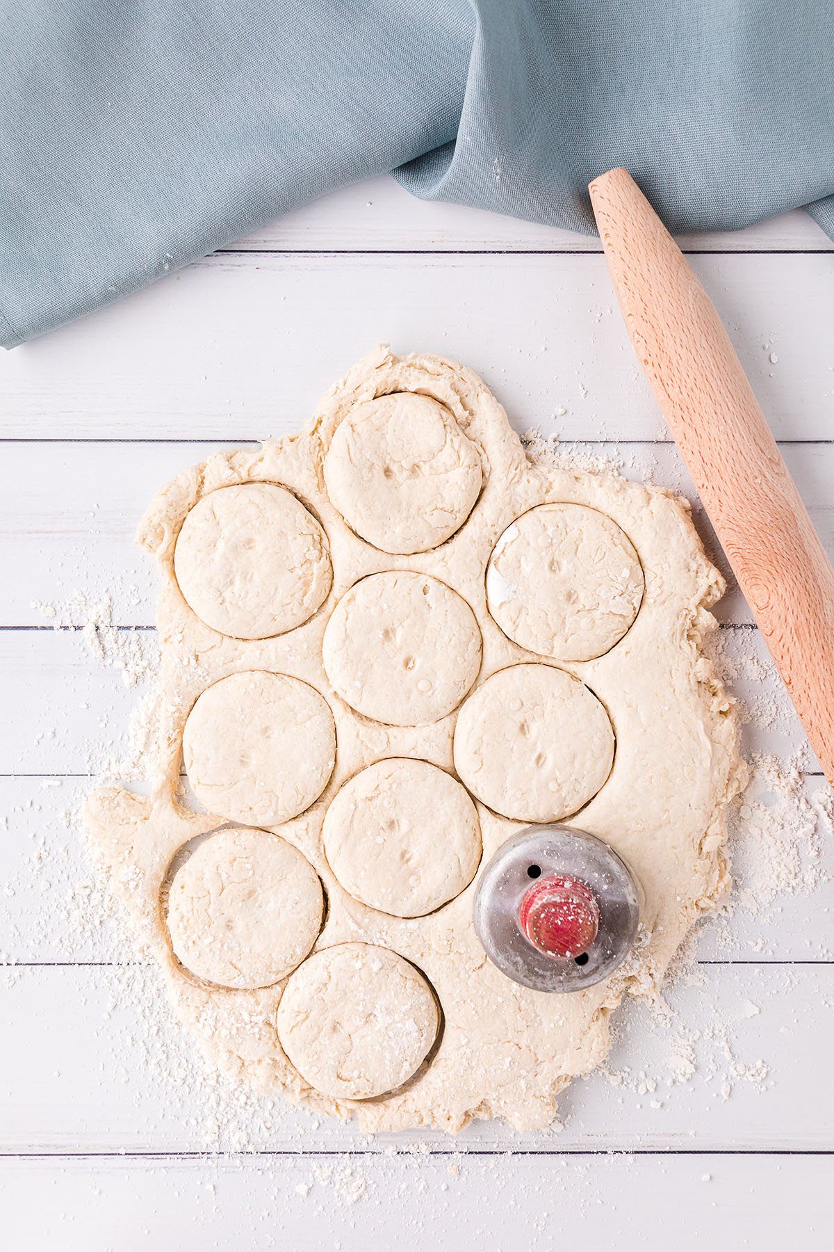 cutting biscuits out of rolled dough with a biscuit cutter