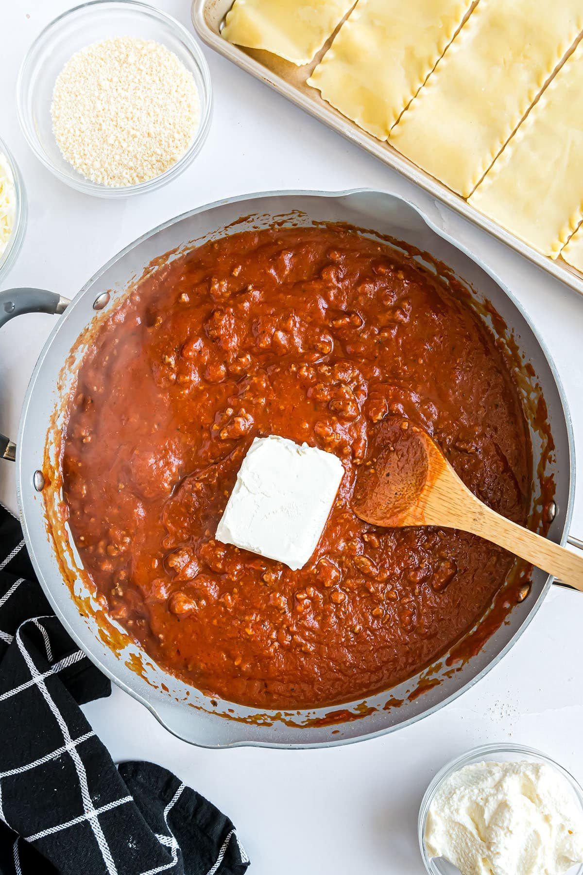 adding cream cheese to lasagna meat sauce