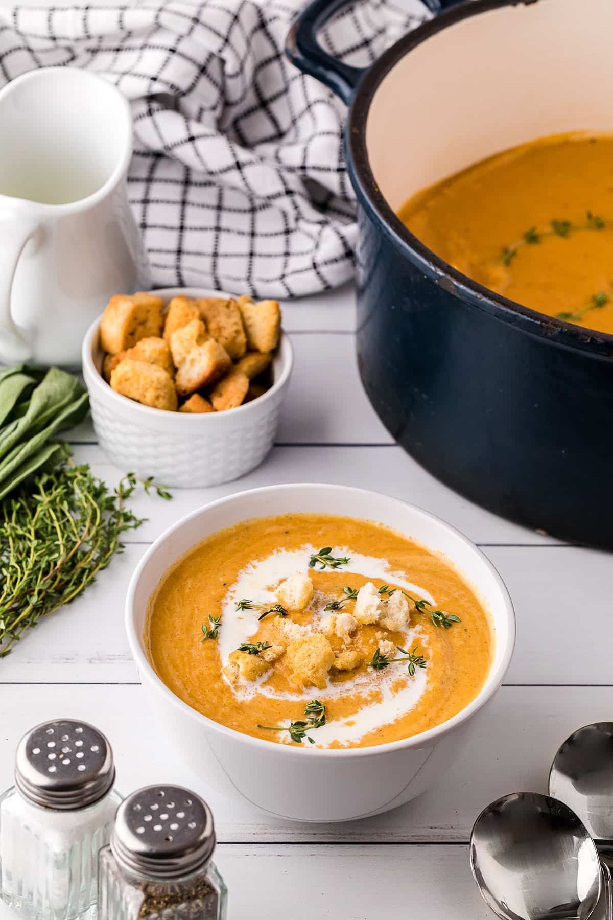 butternut soup with cream, croutons and fresh rosemary on top
