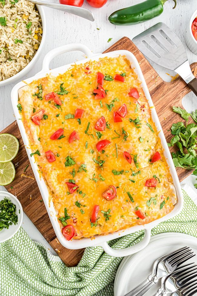 chicken enchiladas made with cream of chicken soup in a white casserole dish