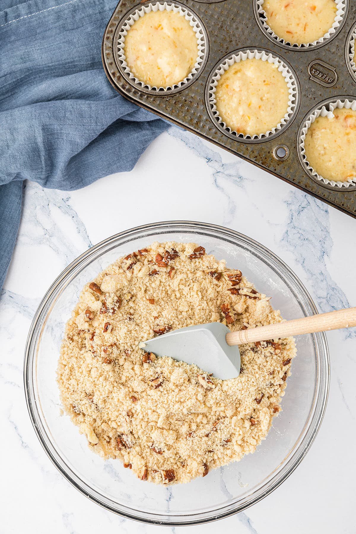 mixing streusel topping in a glass mixing bowl.