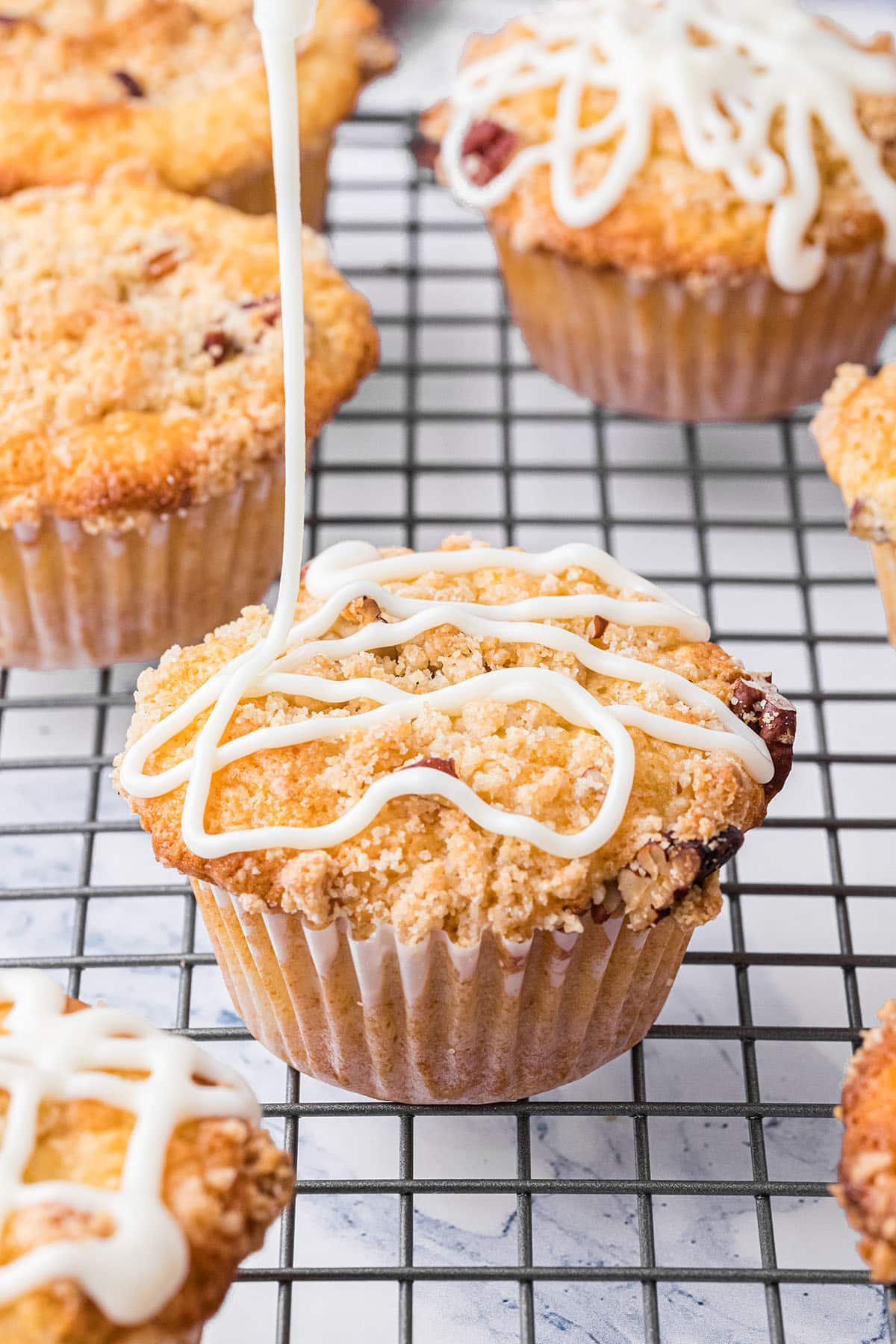 drizzling sugar glaze on muffins