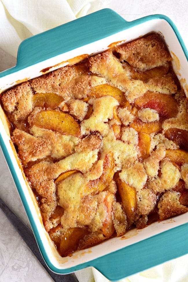 homemade peach cobbler in a blue dish