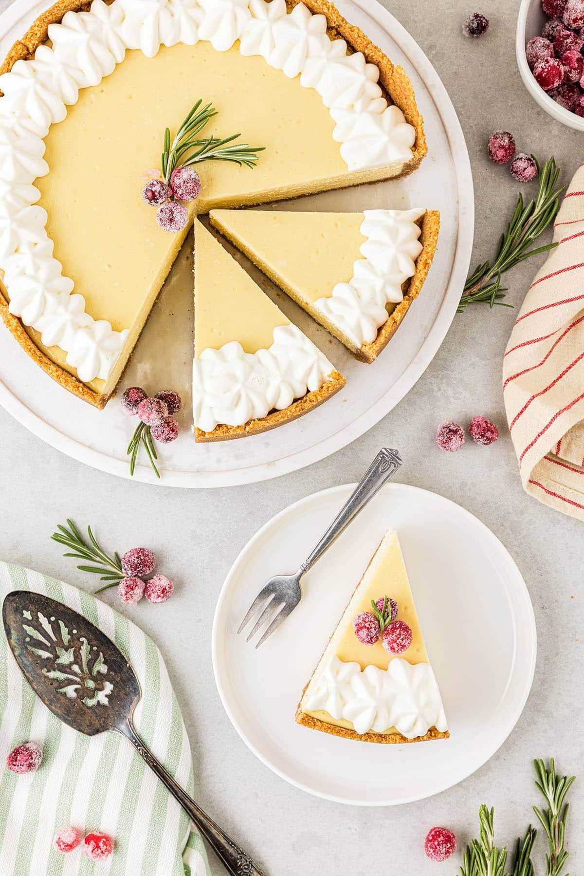 overhead shot of cut cheesecake with one slice on a plate