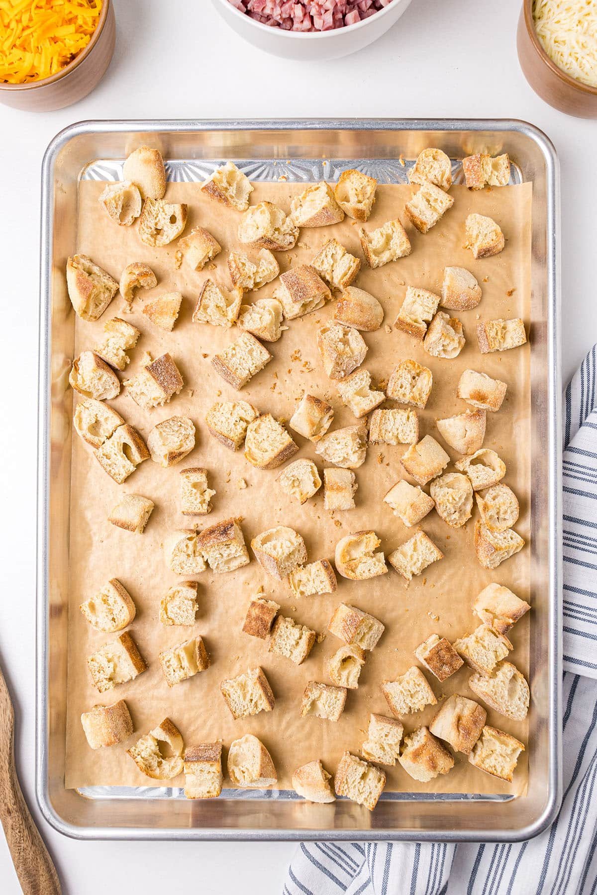 english muffins cut up and on a baking sheet for toasting