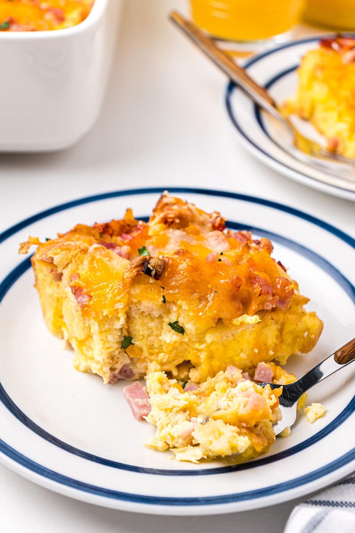 serving of breakfast casserole on a white plate with a fork
