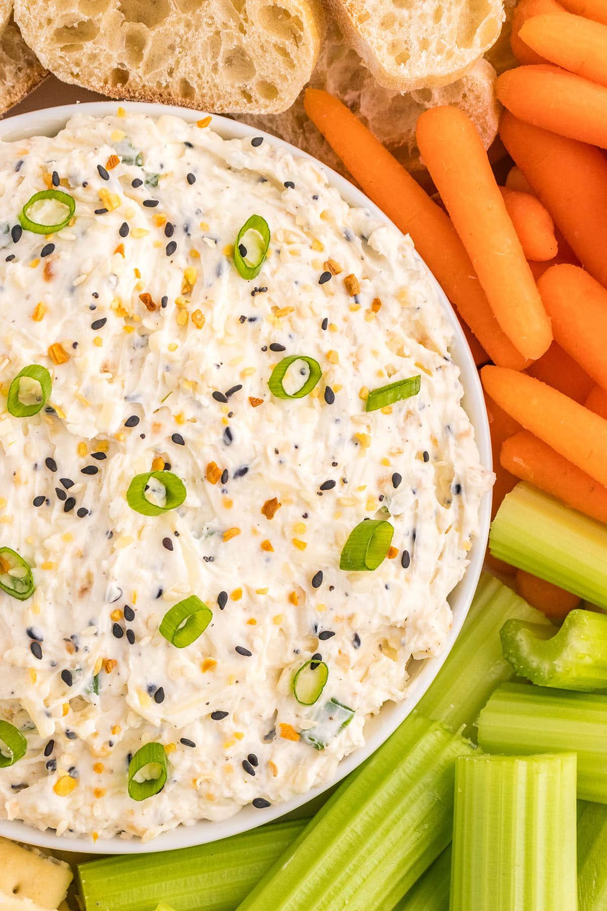 bowl of dip with fresh veggies around it