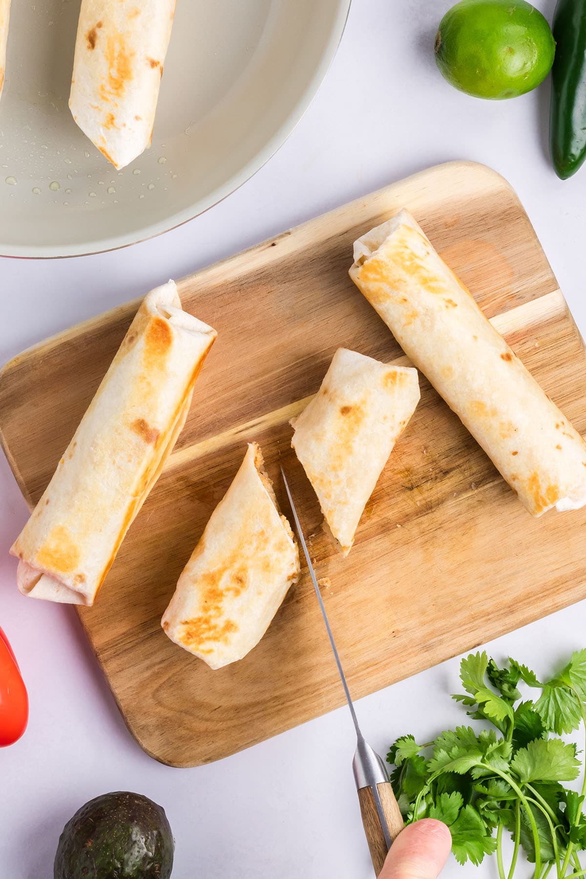 cutting chicken wraps in half for appetizers