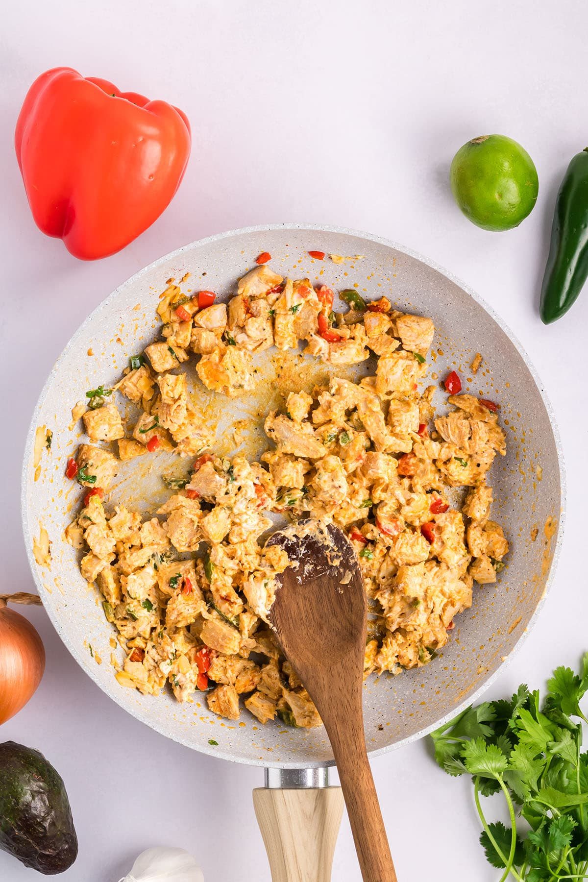 cooking chicken wrap filling in a skillet