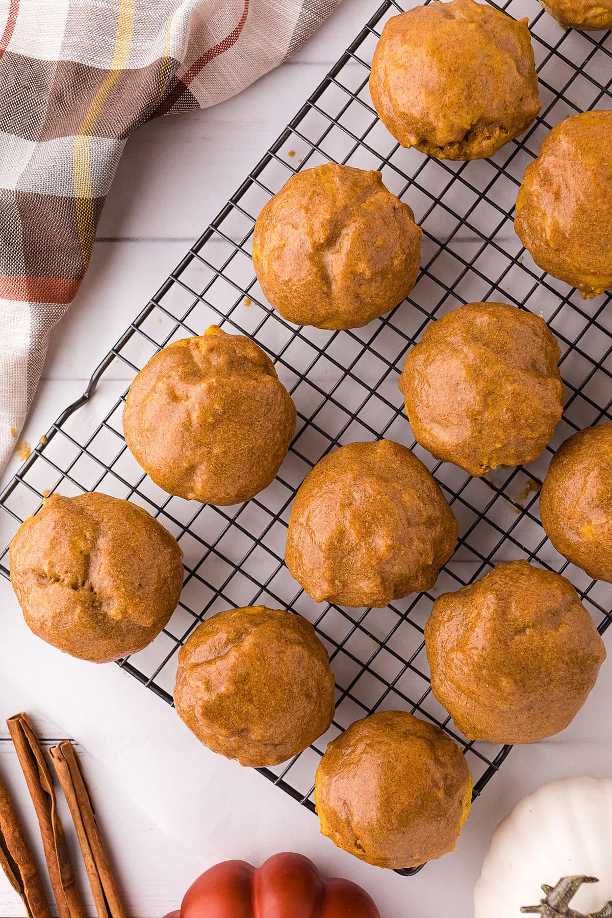 glazed pumpkin muffins on a wire cooling rack