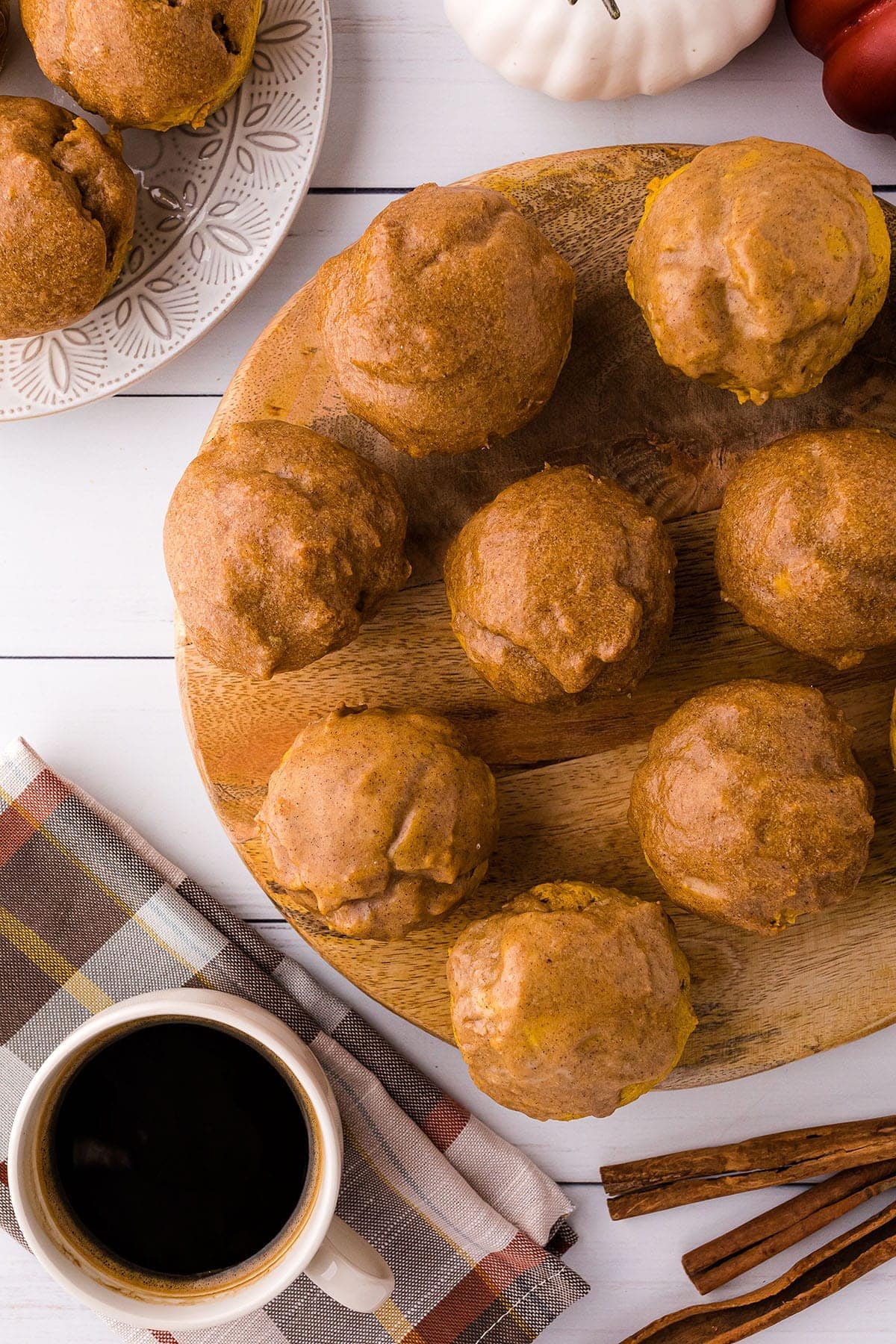 round platter with pumpkin doughnut muffins and a cup of coffee