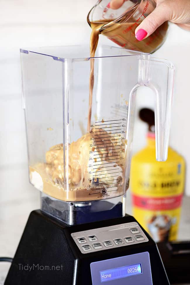 pouring Gooey Butter Cake Cold Brew Milkshake ingredients into blender