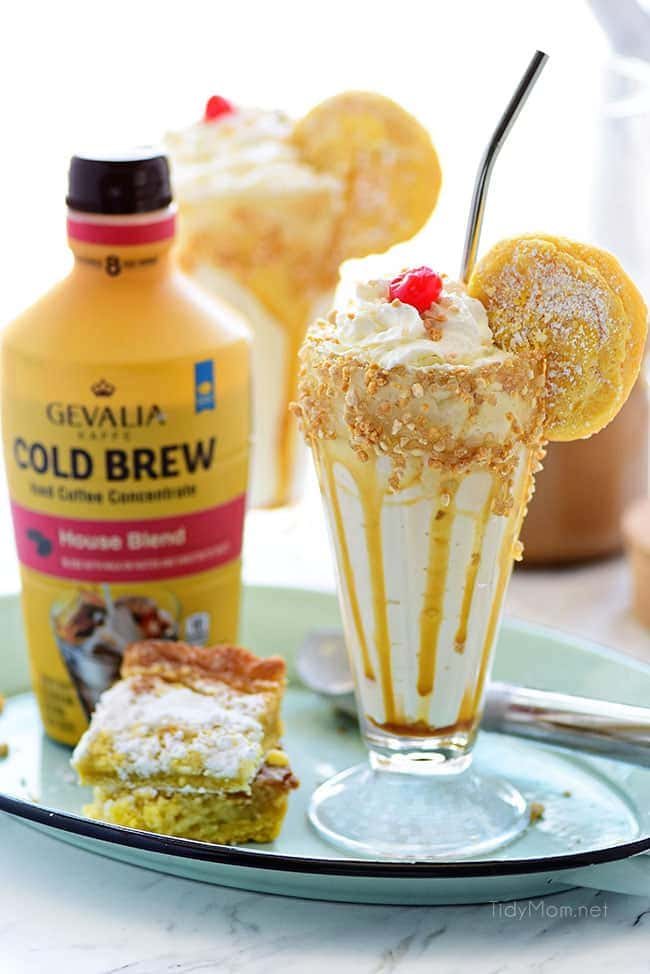 Gooey Butter Cake Cold Brew Milkshake with bottle of Gevalia Cold Brew Concentrate and gooey butter cake on tray.