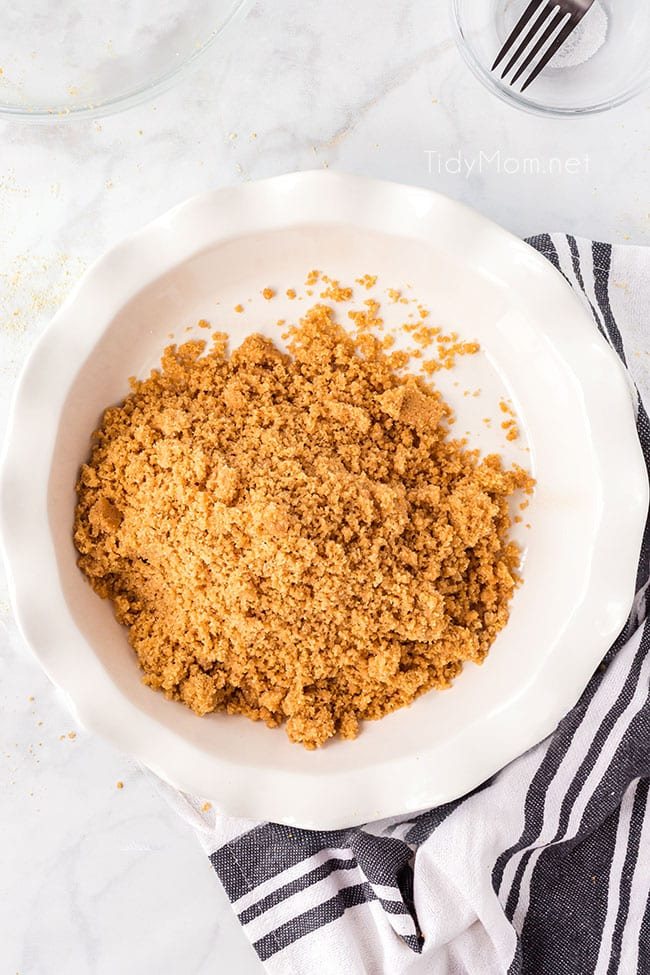 graham cracker crumbs in a white pie dish
