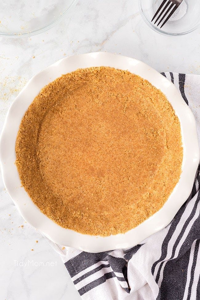Homemade graham cracker pie crust in a white dish
